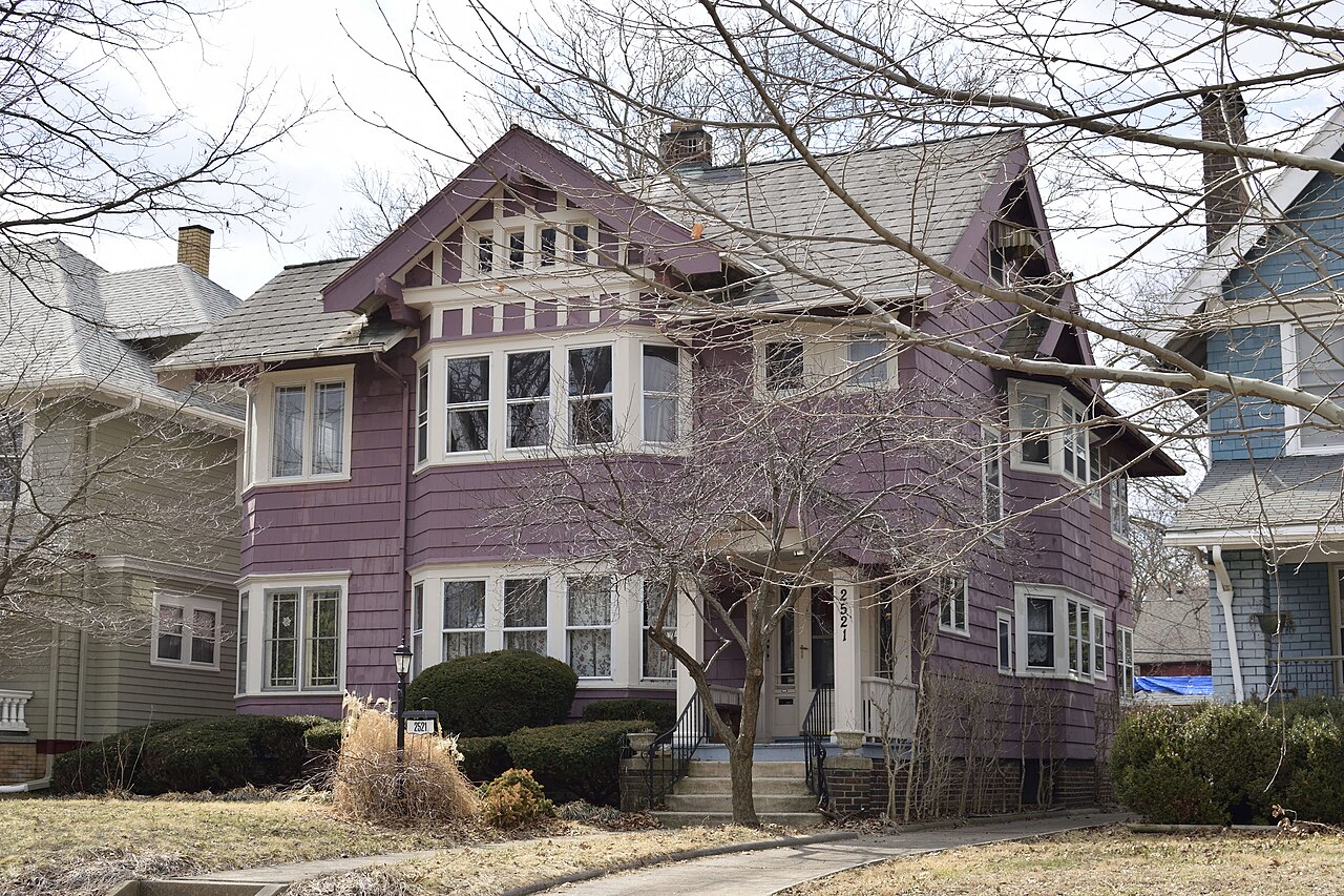 Exterior of a multi-story Texas apartment building with stucco walls and balconies.