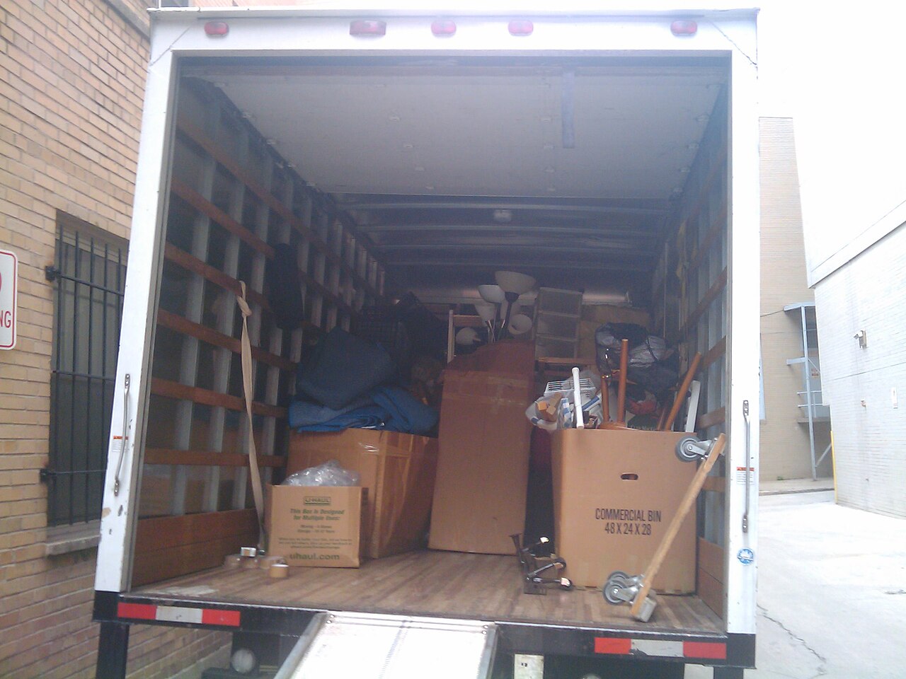 Moving boxes stacked and labeled in a hallway &mdash; the visual setup of a new homeowner's 14-day countdown.