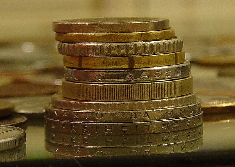 Stacked coins in growing piles &mdash; representing utility deposits ranging from $0 to $400 per service.