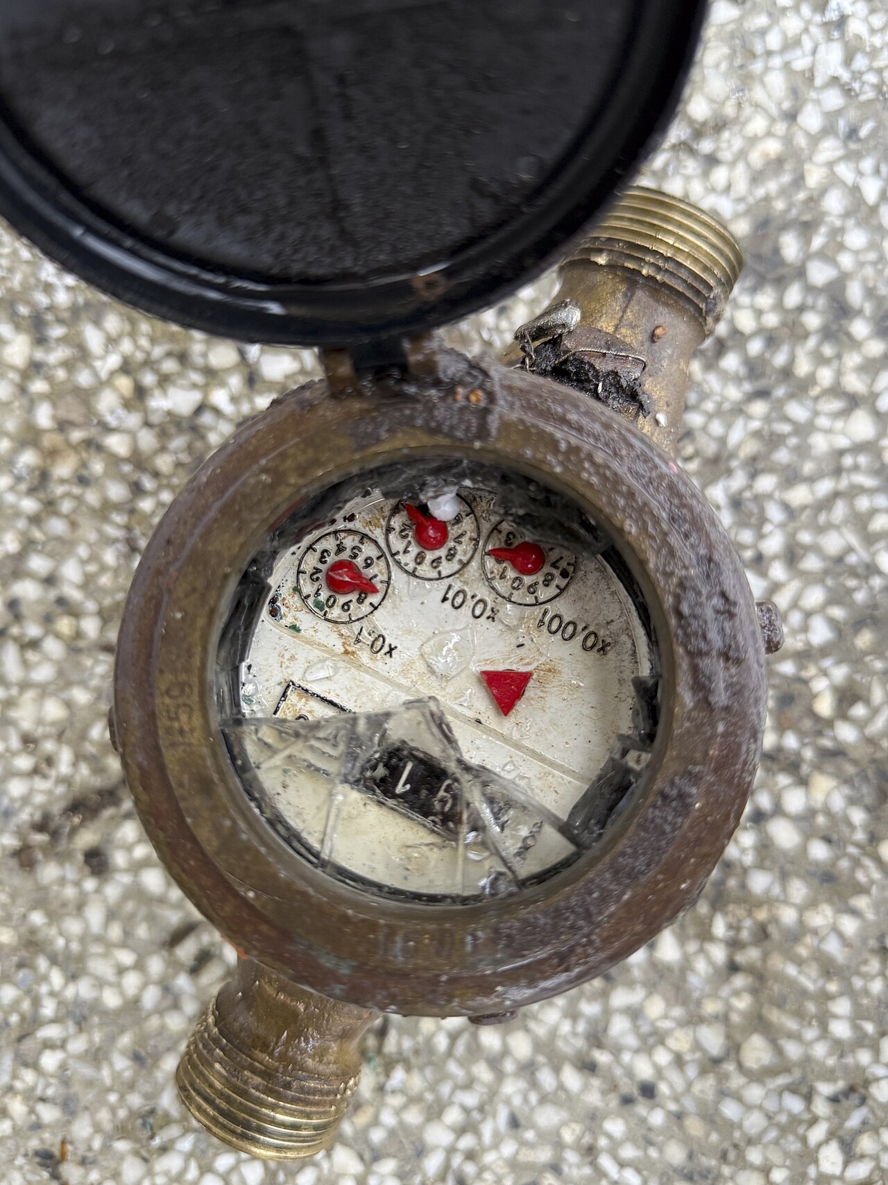 Close-up of a residential water meter showing usage measurements through the round dial — the meter that reports usage to the MUD billing system.
