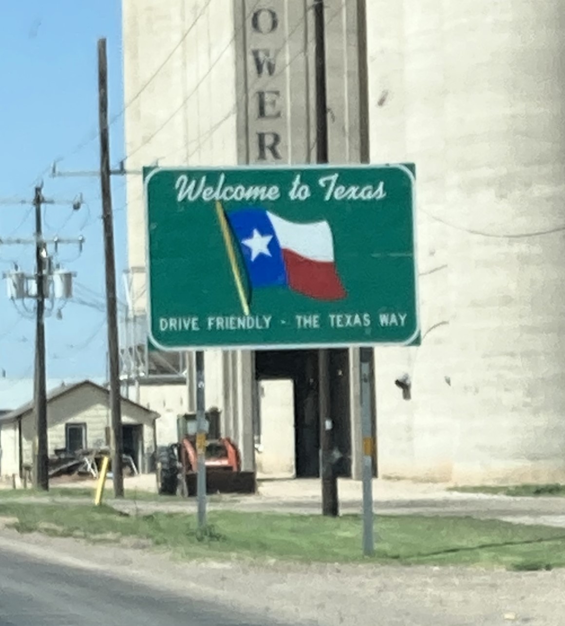 A green-and-white 'Welcome to Texas' highway sign featuring the state outline and a Lone Star — the marker every new resident crosses.